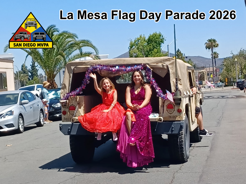 Girls in formal dresses riding in Humvee